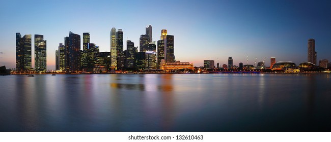 Panorama of a big city with tall buildings reflected in a water. Singapore - Powered by Shutterstock