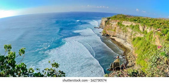 Panorama of Big cliffs with perfect waves on a sunny day at Uluwatu, Bali Indonesia