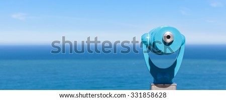 panorama of binoculars and ocean in the background