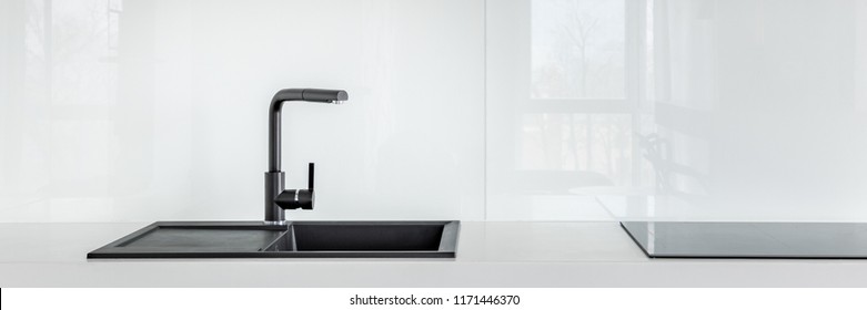 Panorama Of Black Kitchen Sink On High Gloss White Countertop