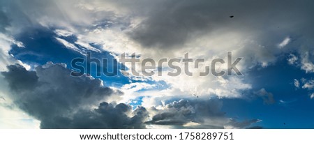 Panorama of blue sky with clouds. Fluffy white unique clouds. Like heaven. Fantastic soft clouds against blue sky, natural composition. Copy space.