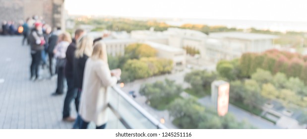 Panorama Blurred Motion Diverse Group Of People In Formal Dress Hanging Out At Rooftop Bar In Downtown Chicago, USA. Business Happy Hour Concept, Autumn Season