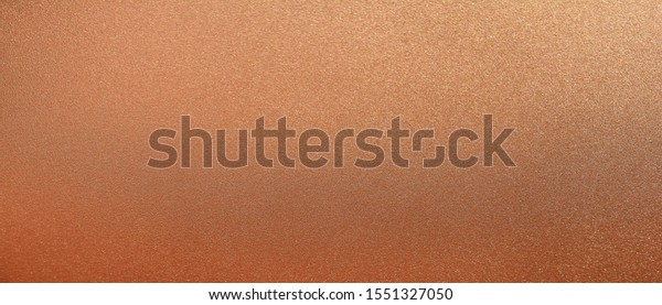 Panorama\
bronze texture background. Panoramic shiny smooth bronze texture\
surface. Glitter and glossy copper\
texture