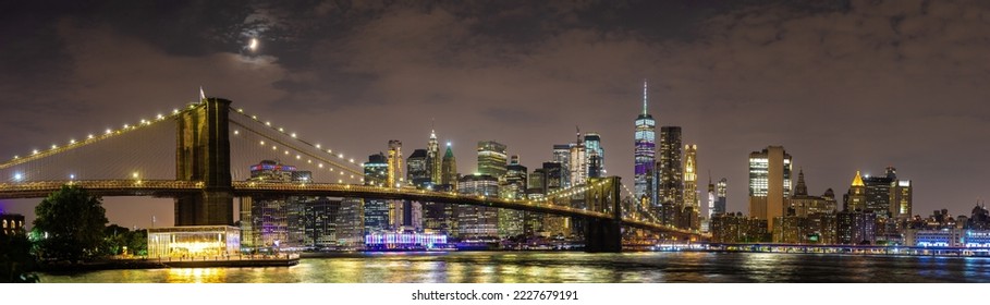 Panorama of  Brooklyn Bridge and panoramic night view of downtown Manhattan after sunset in New York City, USA - Powered by Shutterstock