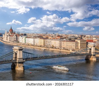 Panorama of Budapest with chain bridge, building of parliament and tourist boat on Danube river in Hungary