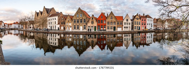 Panorama with Buildings with reflections  around channels in Bruges at sunset, Belgium