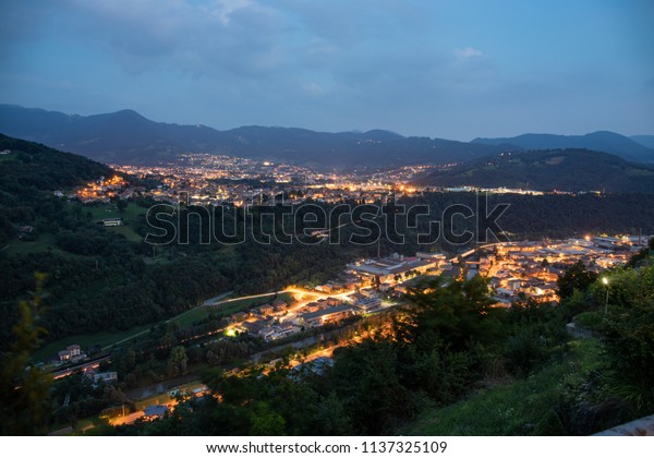 panorama by night, with light trails of\
traffic cars. Vertova, Bergamo, Italy,\
Europe