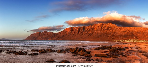 Panorama Of Caleta De Famara Beach, Famous Surfing Resort On Lanzarote, Canary Islands, Spain.