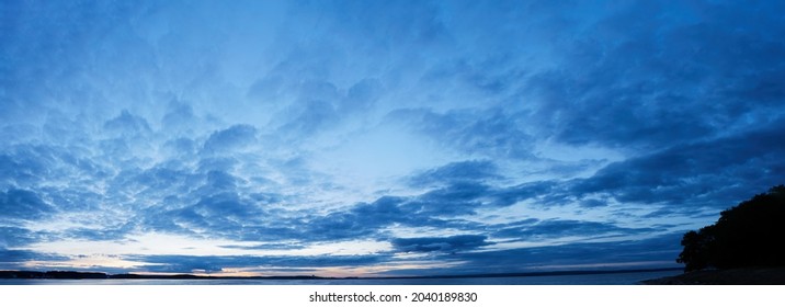Panorama of Calm evening sky with clouds. Sky background after sunset. Sunrise sky with lighted clouds, Beauty evening sunrise over sea - Powered by Shutterstock