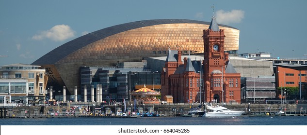 Panorama of Cardiff Bay taken from the water on a sunny day, with the sun bouncing off the copper roof of the Wales Millennium Centre - Shutterstock ID 664045285