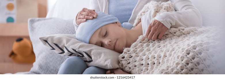 Panorama Of Caregiver Supporting Sleeping Sick Child With Cancer In The Hospice