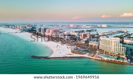 Panorama of city Clearwater Beach FL. Summer vacations in Florida. Beautiful View on Hotels and Resorts on Island. Blue color of Ocean water. American Coast or shore Gulf of Mexico. Sky after Sunset.