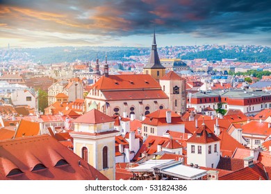 Panorama of the city from the Clock Tower in Prague. Red tiled roofs of the houses in the old part of the city on the background of beautiful sunset sky. Aerial view - Powered by Shutterstock