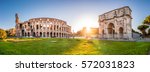 Panorama of Colosseum and Constantine arch at sunrise in Rome. Rome architecture and landmark. Rome Colosseum is one of the main attractions of Rome and Italy.