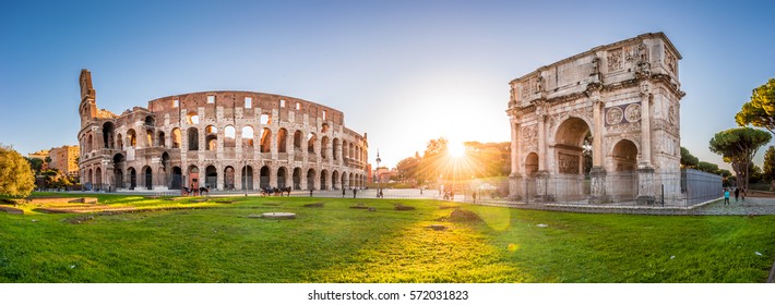 Panorama of Colosseum and Constantine arch at sunrise in Rome. Rome architecture and landmark. Rome Colosseum is one of the main attractions of Rome and Italy.