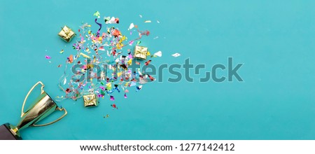 Panorama concept. Celebrating the success that has happened, Gold trophy placed on a blue background. There are gift boxes and colorful ribbons. Free space to put text into advertising media.