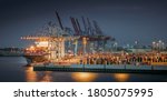 Panorama of a container terminal in the port of Hamburg at night 