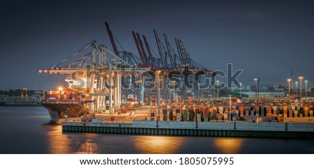Panorama of a container terminal in the port of Hamburg at night 