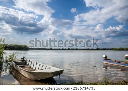 Panorama of the Danube river in Serbia in Krcedin, Vojvodina, with vintage rowing and motor boats anchored on a shore. Danube is Europe's second-longest river. It is located in Central Eastern Europe Stock foto © 