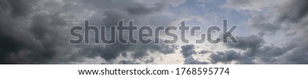 Panorama of dark gray stormy sky, gray clouds cover the sky