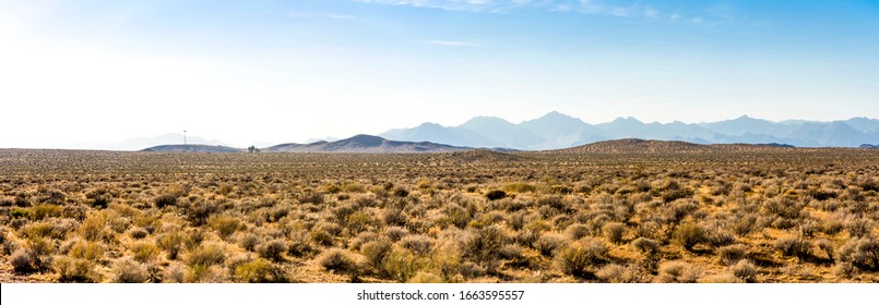 panorama of death valley mountain range on a sunny day with blue sky. the death valley desert on a sunny day