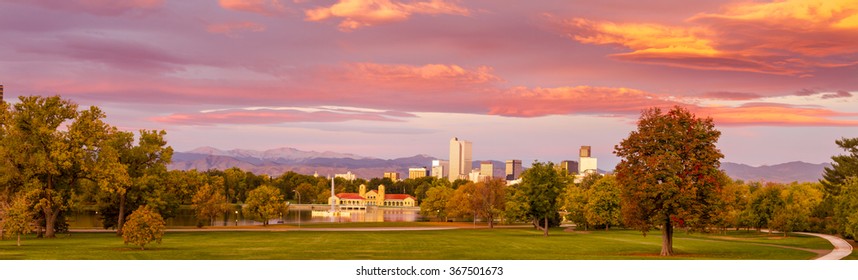 Panorama of Denver Colorado skyline from City Park with City Park Boathouse and Rocky Mountains in background on autumn morning