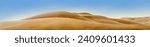 Panorama of desert landscape in Africa with sand dunes in Namib desert, Namibia. Nature background of sandy hills with soft lines and copy space for your design of header or banner, wide format.