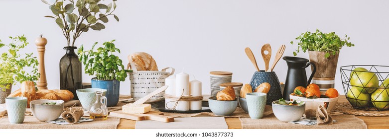 Panorama Of Dining Table With Fruit, Butter, Candles And Olive Oil