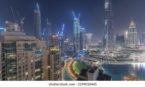 Panorama Of Downtown Dubai City Aerial Night Timelapse. Urban Skyline Of Business Bay With Modern Skyscrapers And Towers Construction Site From Above