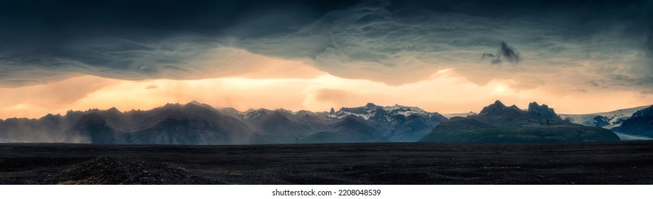 Panorama dramatic of mountain range glacier with asperlitas cloud and sand storm on lava field in the sunset on summer at Iceland