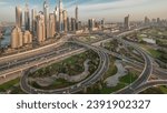 Panorama of Dubai Marina highway intersection spaghetti junction. Illuminated tallest skyscrapers and golf course on a background. Aerial top view from JLT district before sunrise