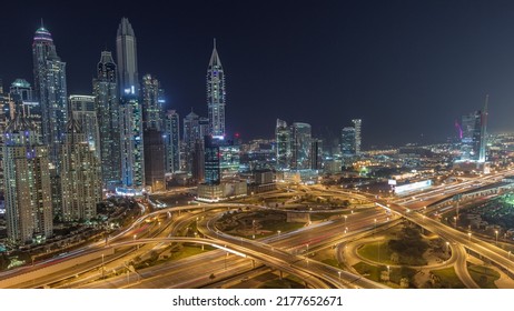 Panorama of Dubai Marina and media city highway intersection spaghetti junction night timelapse. Illuminated tallest skyscrapers on a background. Aerial top view from JLT district. - Shutterstock ID 2177652671
