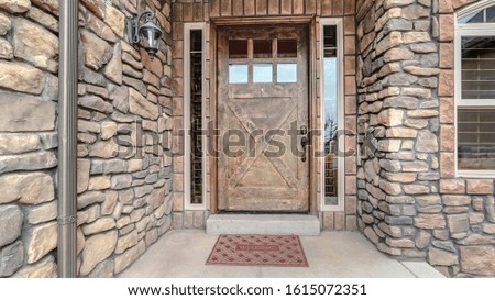 Panorama Entrance door to home with stone brick walls