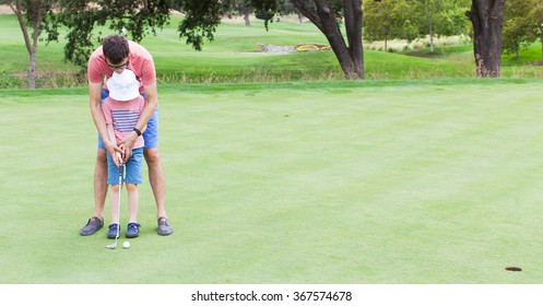 panorama of family at golf field, father teaching his son to play golf