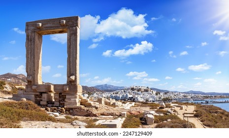 Panorama of the famous gate of Naxos island, so called Portara from the temple of Apollon, in front of the whitewashed houses of the city,  witout people, Cyclades, Greece - Shutterstock ID 2247129409