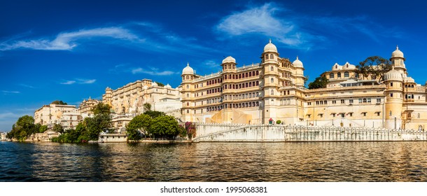 Panorama of famous romantic luxury Rajasthan indian tourist landmark - Udaipur City Palace on sunset with cloudy sky - surface level view. Udaipur, Rajasthan, India