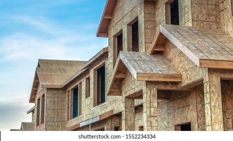 Panorama frame Construction of townhouses viewed against blue sky and clouds on a sunny day - Shutterstock ID 1552234334