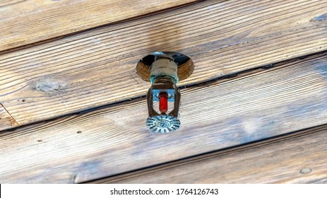 Panorama Frame Fire Sprinkler Head Installed On The Brown Wooden Ceiling Of A Building Or Home