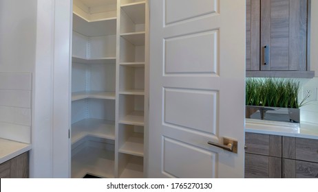 Panorama Frame Small Pantry With Empty Wall Shelves At The Corner Of The Kitchen Of Home