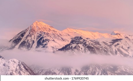 Panorama Frame Snowy Wasatch Mountains With Sharp Peaks Illuminated By Sunset In Winter