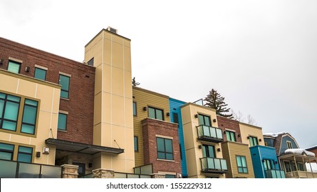 Panorama Front of townhomes with balconies against cloudy winter sky in Park City Utah