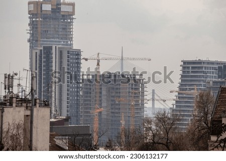 Panorama of a giant Construction site of a residential building complex of skyscraper tower high rises, with scaffholdings, concrete and cement Facades and cranes, in a real estate development area.