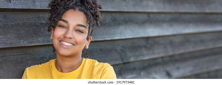 Panorama girl teenager teen female young African American mixed race biracial woman outside smiling with perfect teeth panoramic header web banner - Powered by Shutterstock