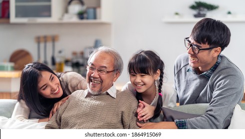 Panorama Group Portrait Of Happy Multigenerational Asian Family Sit On Sofa Couch In Living Room With Smile. Muti Genration Family Happiness Concept.