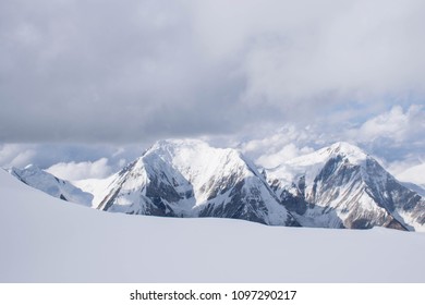 Panorama of high snow mountains in Central Asia with big rock walls and glaciers under the clouds in a cold summer day. - Shutterstock ID 1097290217