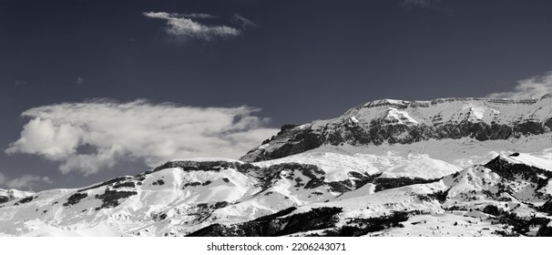 Panorama of high snowy mountains and sky with clouds at sunny winter day. Caucasus Mountains, Shahdagh, Azerbaijan. Black and white toned landscape. - Shutterstock ID 2206243071