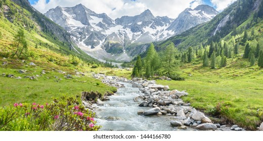 Panorama Of A Hiking Area In The Alps With Torrent And Glacier In The Background