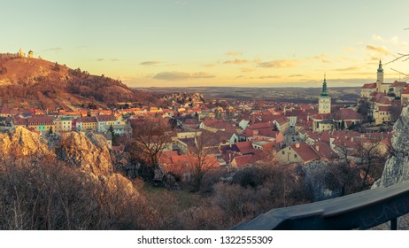 Panorama of the historic city at dusk. On the left is the Holy Hill with the cross, the right is the chateau. Beautiful evening light. South Moravia, Mikulov.