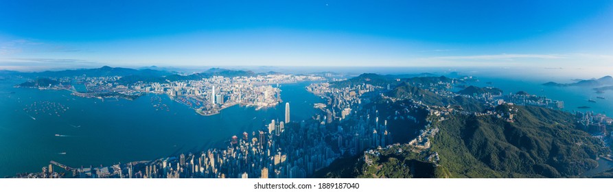 Panorama of Hong Kong Island from the peak, commercial center downtown surrounded by mountains, evening