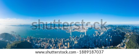 Panorama of Hong Kong Island from the peak, commercial center downtown surrounded by mountains, evening